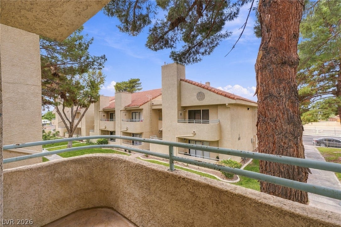 830 N Sloan Lane, #202, Las Vegas, NV 89110 Mature trees frame the neighborhood view from this elevated private balcony.