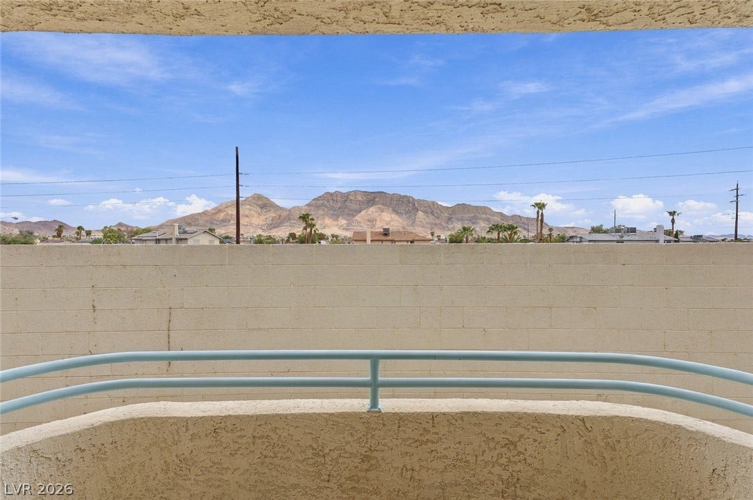 830 N Sloan Lane, #202, Las Vegas, NV 89110 Distant mountain peaks rise beyond the courtyard wall of this elevated outdoor space.