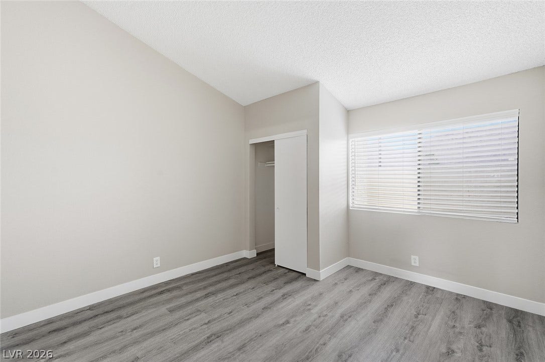 830 N Sloan Lane, #202, Las Vegas, NV 89110 Slanted ceilings and wood-style flooring elevate this comfortable secondary bedroom.