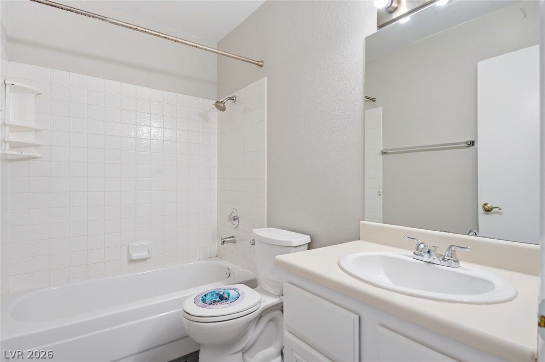 830 N Sloan Lane, #202, Las Vegas, NV 89110 A classic tiled shower tub combination anchors this clean bathroom space.