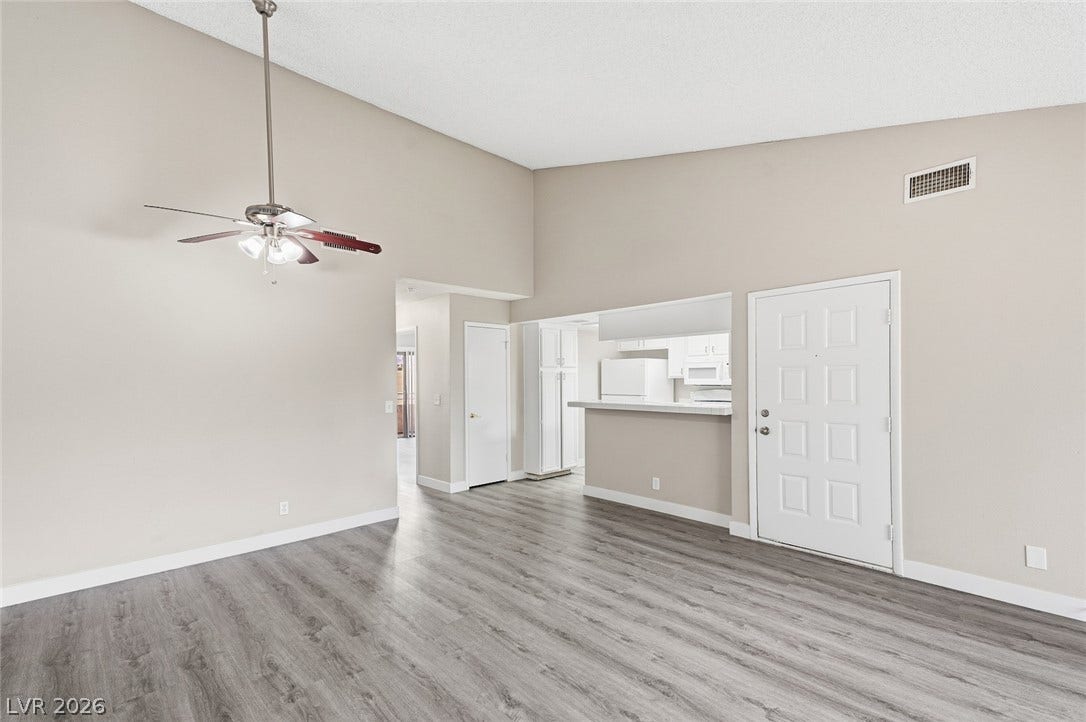 830 N Sloan Lane, #202, Las Vegas, NV 89110 Vaulted ceilings and durable laminate flooring create a welcoming interior flow.