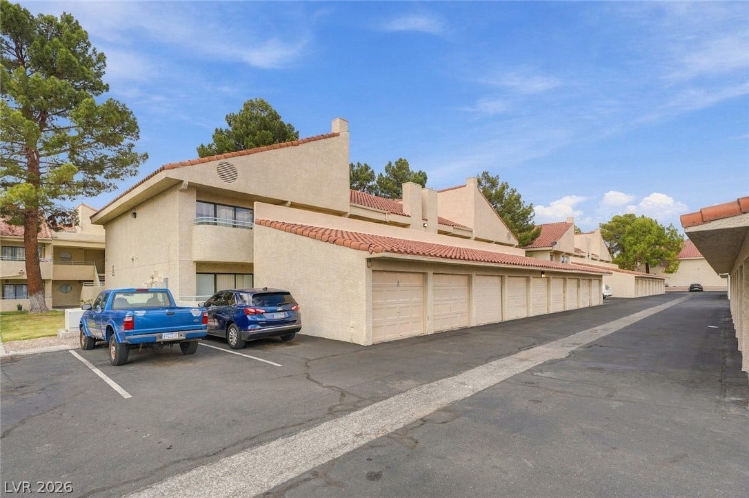 830 N Sloan Lane, #202, Las Vegas, NV 89110 Spanish tile roofs and stucco exteriors define this multi-unit residential community with garage parking.