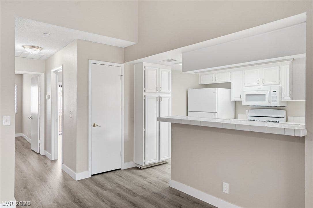 830 N Sloan Lane, #202, Las Vegas, NV 89110 High ceilings and durable wood-look flooring enhance this inviting open floorplan layout.
