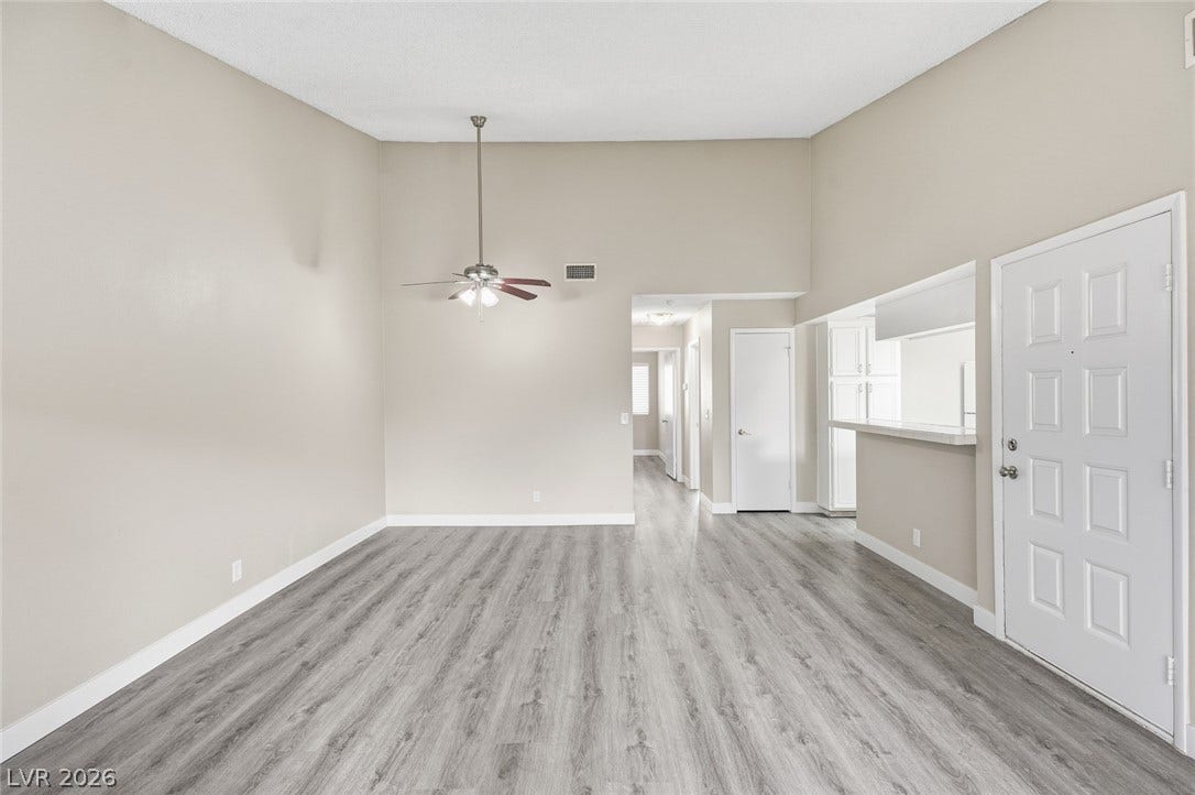 830 N Sloan Lane, #202, Las Vegas, NV 89110 An open main level showcases wood-look flooring and an adjacent breakfast bar.