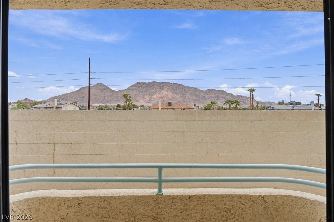 830 N Sloan Lane, #202, Las Vegas, NV 89110 Dramatic mountain ranges frame the horizon beyond a private covered balcony.
