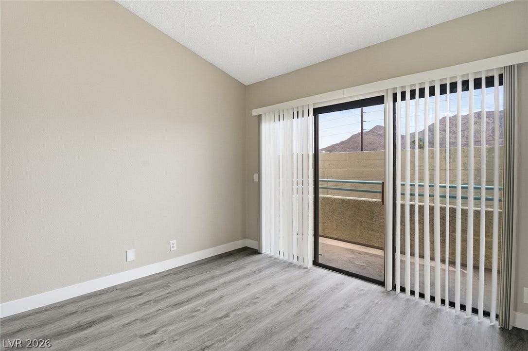 830 N Sloan Lane, #202, Las Vegas, NV 89110 Sliding glass doors open directly to a private balcony overlooking scenic mountain peaks.