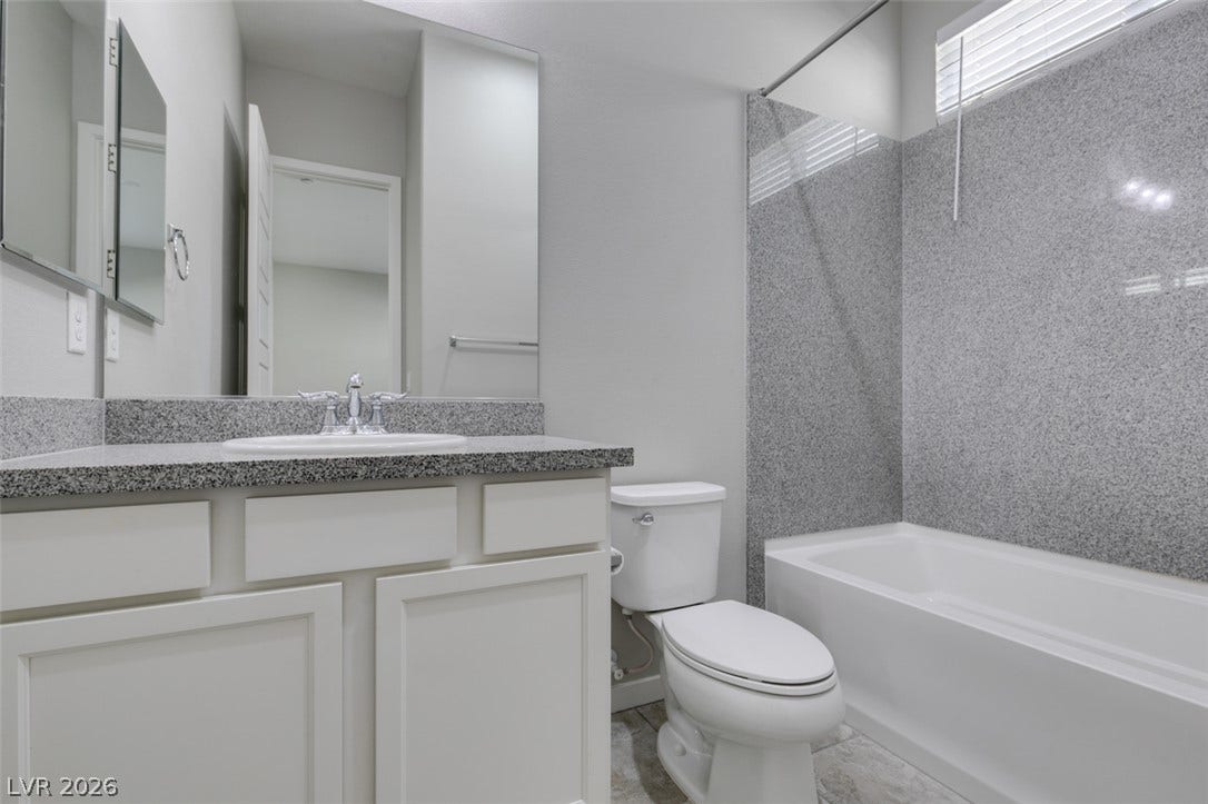 Polished granite countertops complement the clean lines of this modern bathroom space.