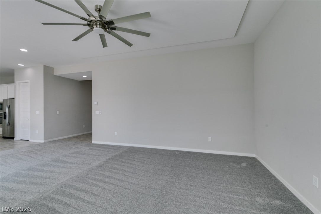 Plush wall-to-wall carpeting and clean architectural lines define this versatile open living space.