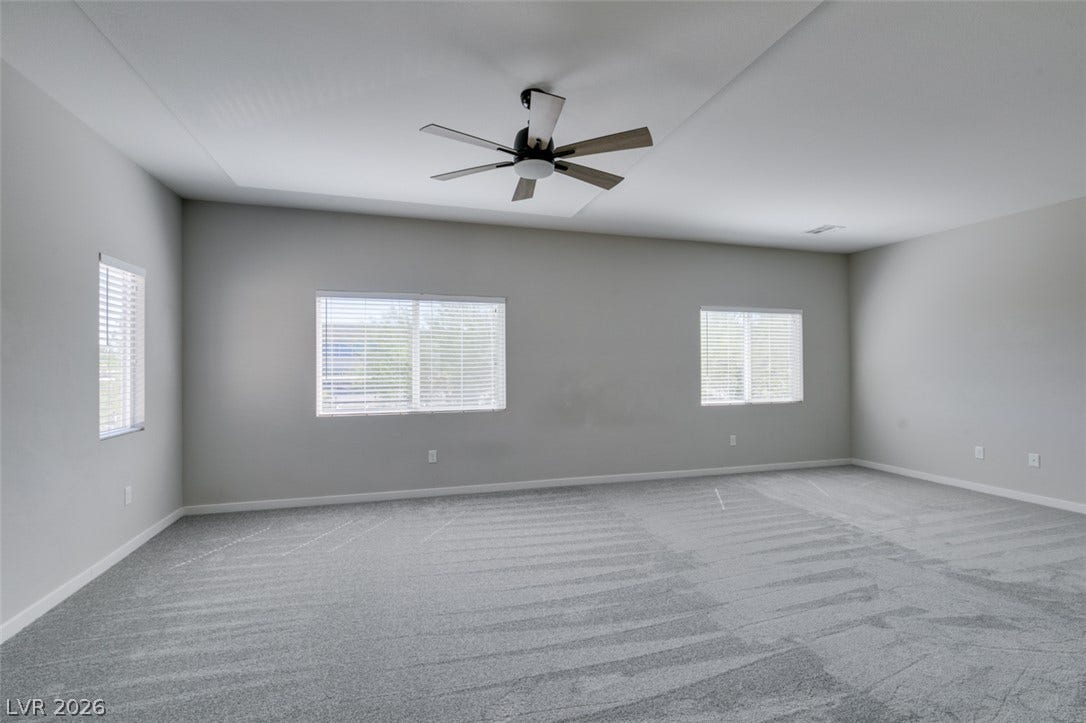 Plush wall-to-wall carpeting and tall ceilings frame this versatile upstairs bonus area.