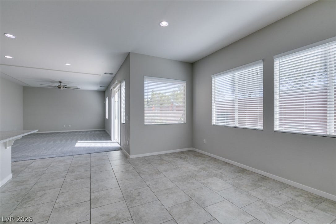 An open floorplan connects the tile-floored dining area to a spacious living room.