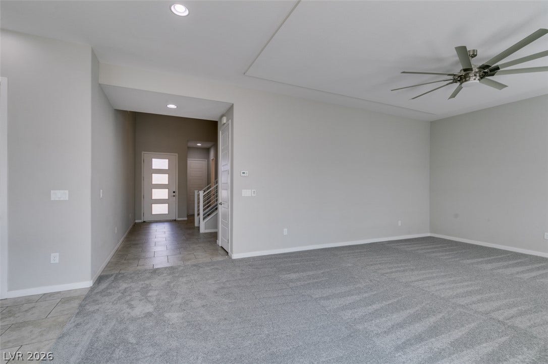 An open layout connects the carpeted living space to a tiled entryway.