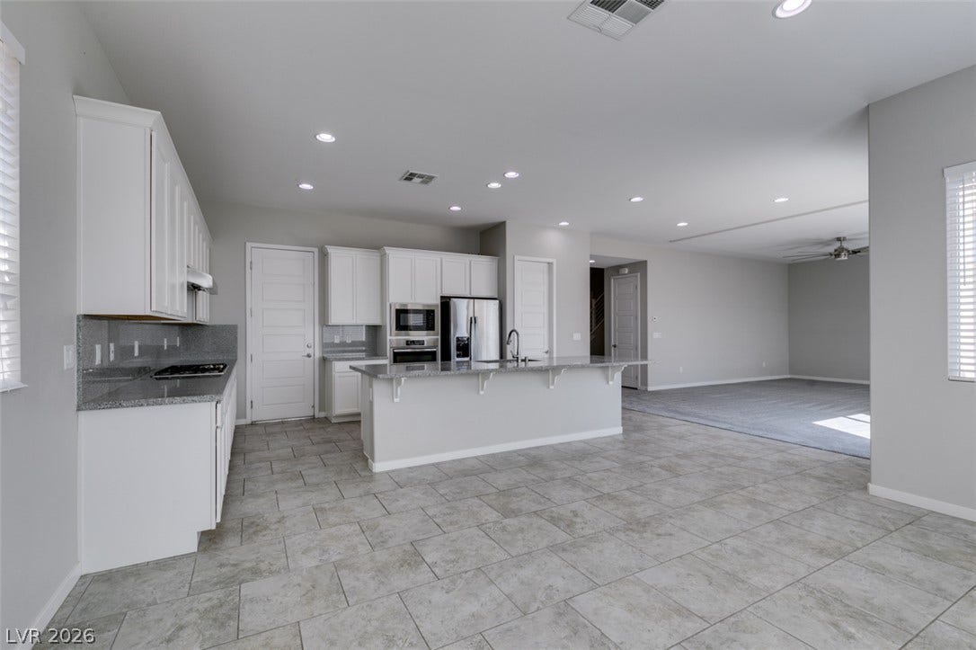 An open floor plan seamlessly connects the kitchen to the adjacent living space.