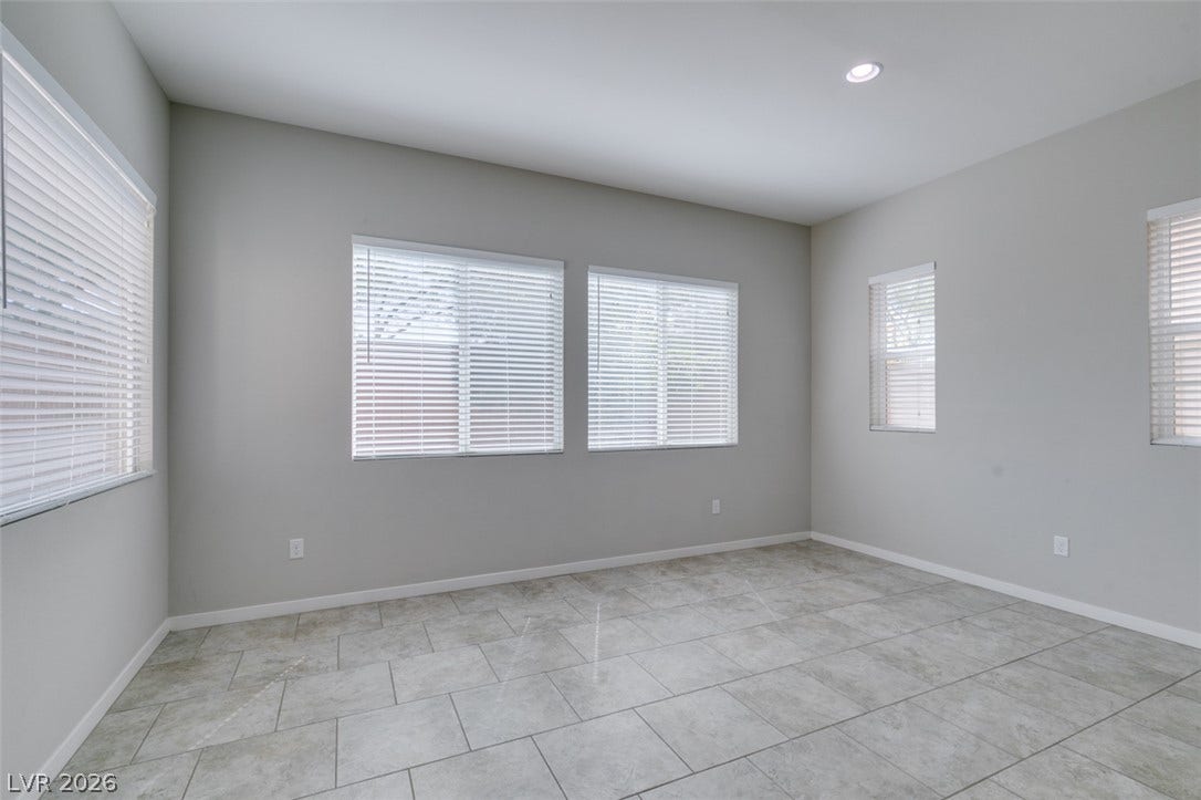 Polished tile flooring and multiple windows establish a bright, airy architectural character.