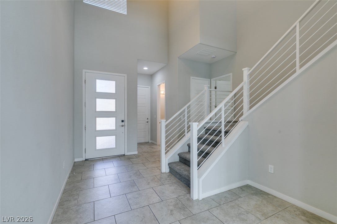 Towering ceilings and tile flooring create an immediate sense of scale upon entry.