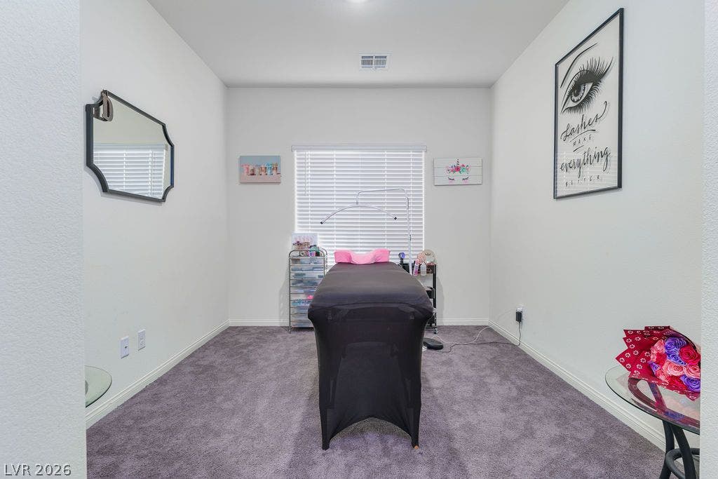 6135 Larimar Gold Street, North Las Vegas, NV 89115 Plush carpeting and a bright window highlight this versatile, neutral-toned bonus room.