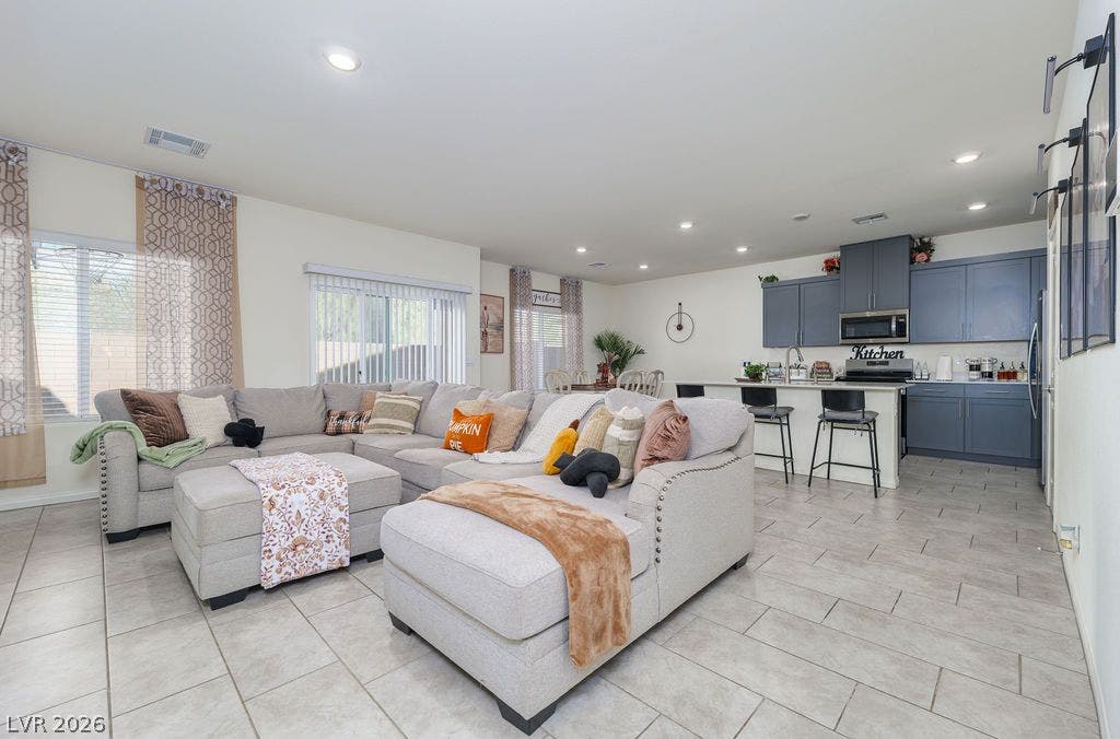 6135 Larimar Gold Street, North Las Vegas, NV 89115 An open layout links the comfortable living area seamlessly with a modern kitchen.