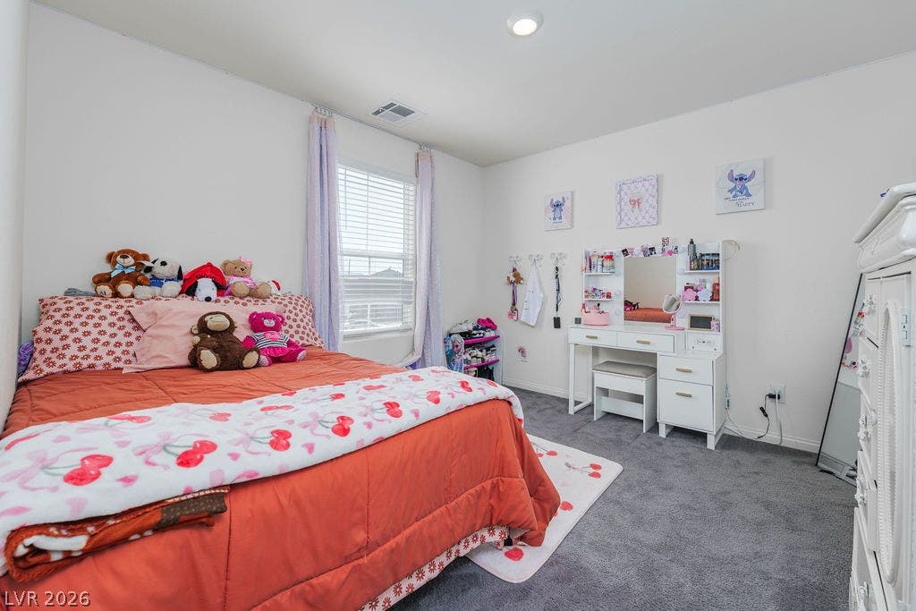 6135 Larimar Gold Street, North Las Vegas, NV 89115 Soft carpet and recessed lighting enhance this cozy bedroom featuring a bright window.