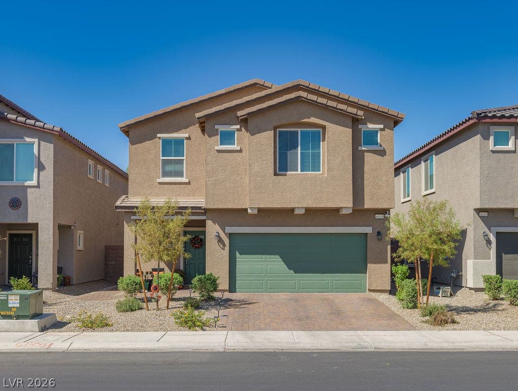 6135 Larimar Gold Street, North Las Vegas, NV 89115 Stucco exterior siding and tile roofing define this contemporary two-story residence.