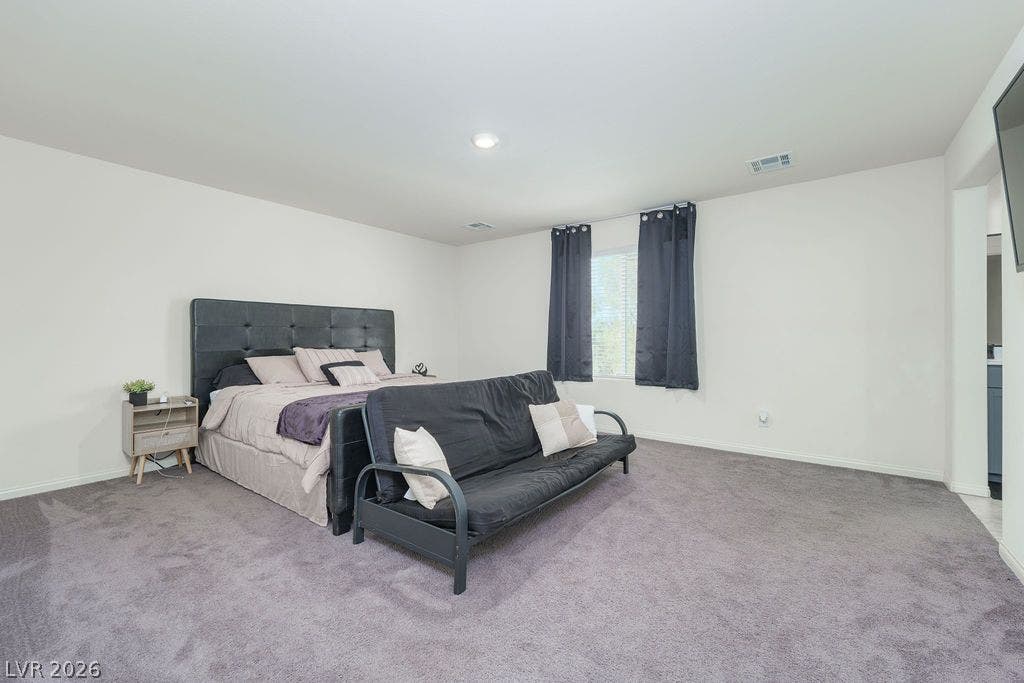 6135 Larimar Gold Street, North Las Vegas, NV 89115 Plush wall-to-wall carpeting and clean lines define this generous bedroom space.