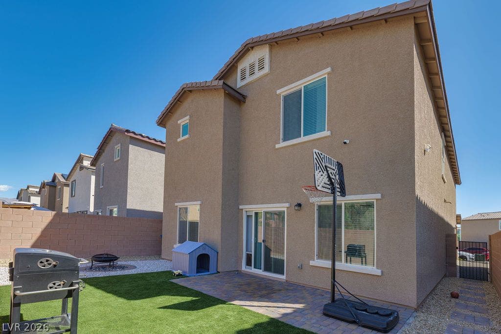 6135 Larimar Gold Street, North Las Vegas, NV 89115 A paved patio and tidy lawn area define this private backyard setting.