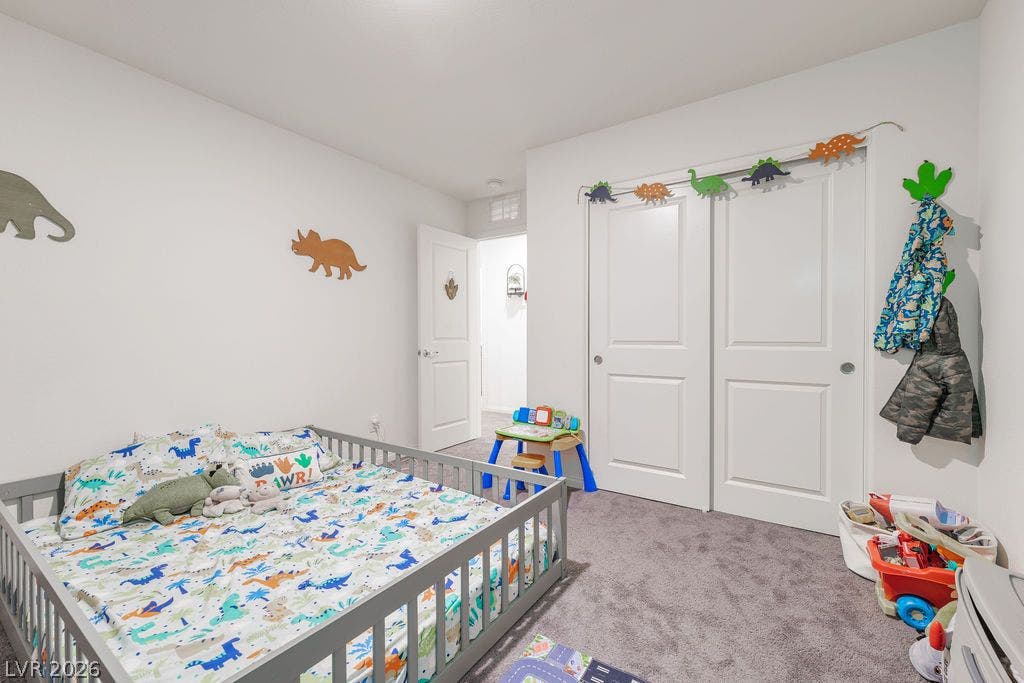6135 Larimar Gold Street, North Las Vegas, NV 89115 Soft carpeting and integrated closet space anchor this comfortable secondary bedroom.