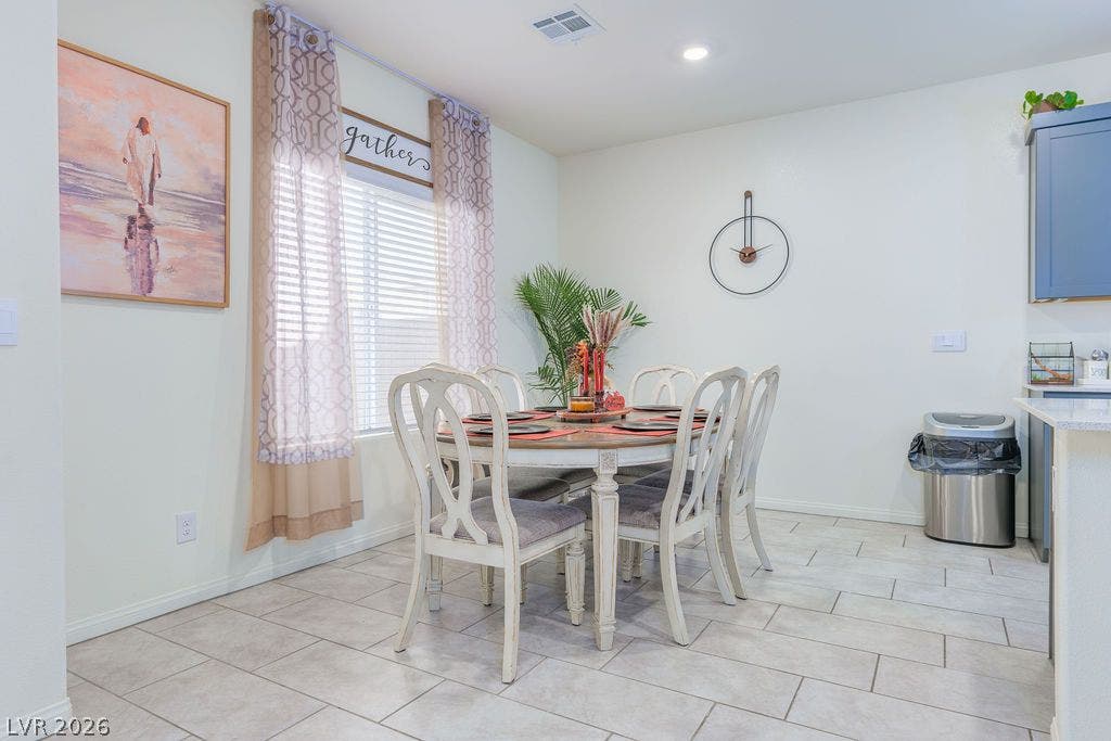 6135 Larimar Gold Street, North Las Vegas, NV 89115 Tiled flooring and a bright window accent this inviting dining space adjacent to the kitchen.
