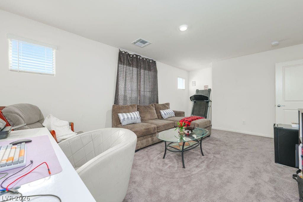 6135 Larimar Gold Street, North Las Vegas, NV 89115 Recessed lighting and soft carpeting create a comfortable atmosphere in this versatile living space.