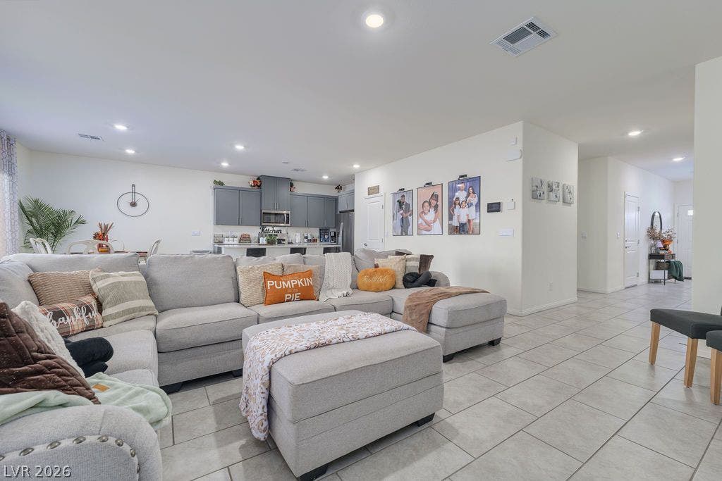 6135 Larimar Gold Street, North Las Vegas, NV 89115 Gleaming tile floors and recessed lighting enhance this airy, open-concept living space.