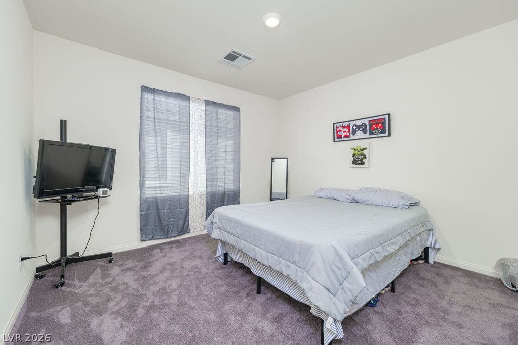 6135 Larimar Gold Street, North Las Vegas, NV 89115 Plush carpeting underfoot and ample natural light define this cozy secondary bedroom.