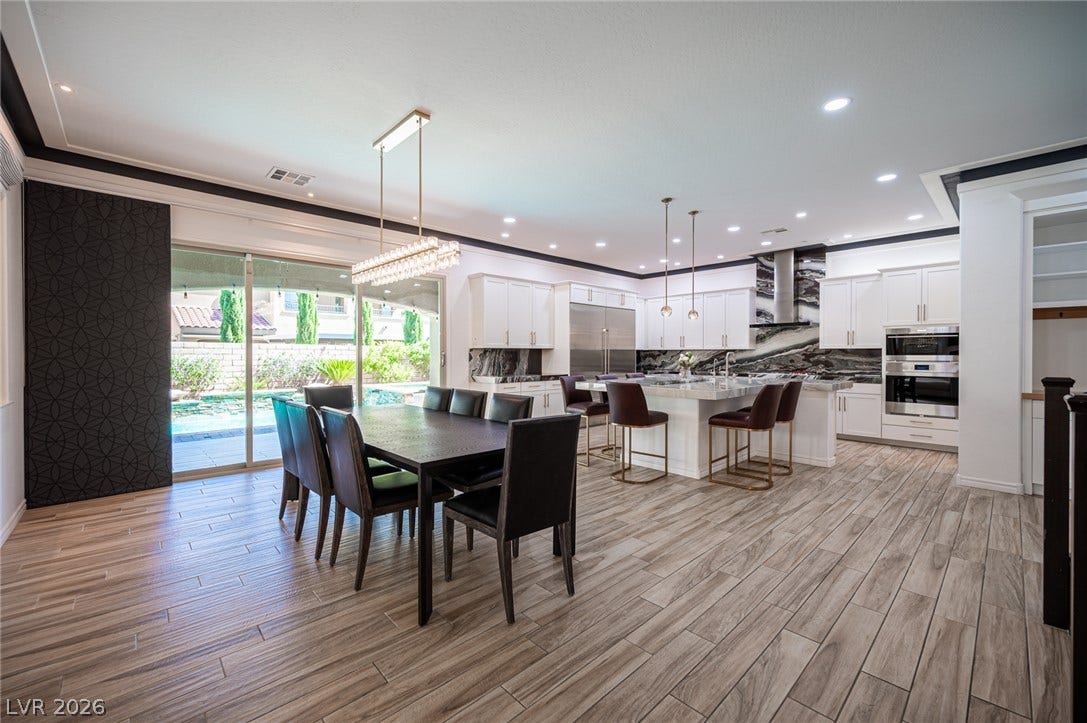 322 Elder View Drive, Las Vegas, NV 89138 Wood-look tile floors unify this open space overlooking the pool.