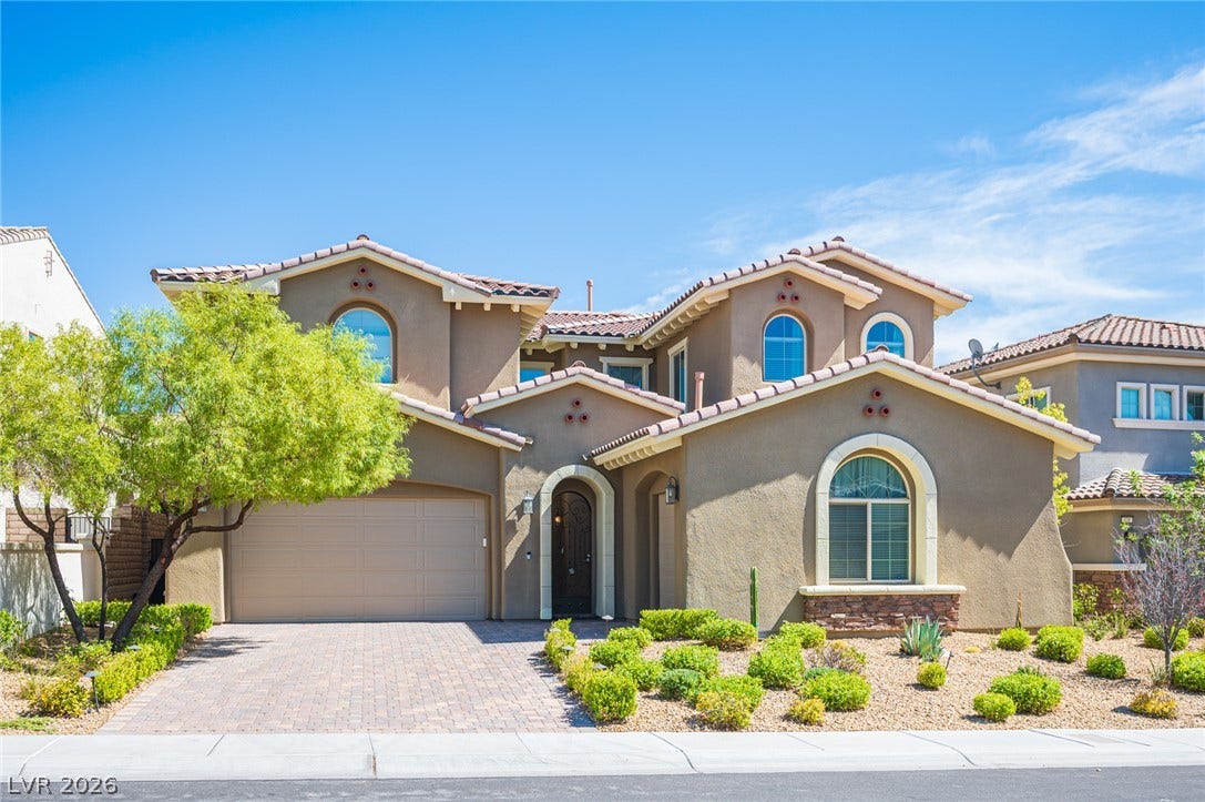 322 Elder View Drive, Las Vegas, NV 89138 Stucco walls and tiled rooflines define the exterior of this two-story desert residence.