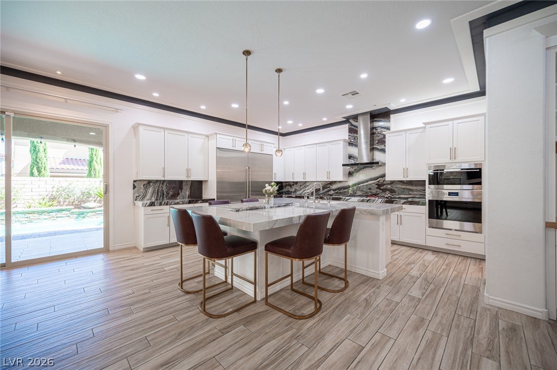 322 Elder View Drive, Las Vegas, NV 89138 Elegant wood-look tile flooring and a central island anchor this gourmet kitchen space.