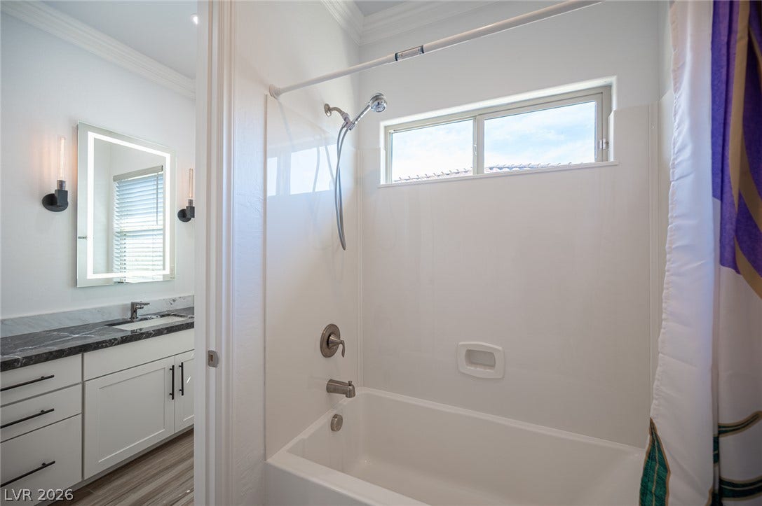 322 Elder View Drive, Las Vegas, NV 89138 Crown molding and a classic bathtub shower configuration highlight this bright secondary bathroom.