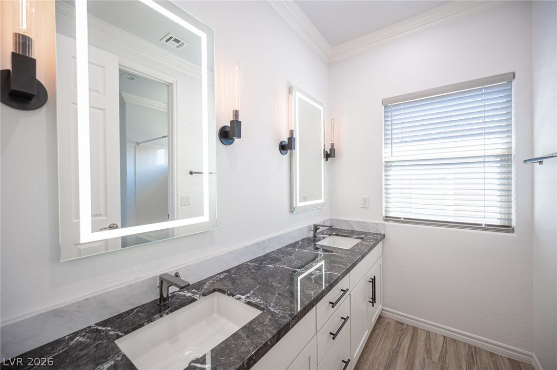 322 Elder View Drive, Las Vegas, NV 89138 Exquisite dark stone countertops bring timeless elegance to this modern double vanity bathroom.