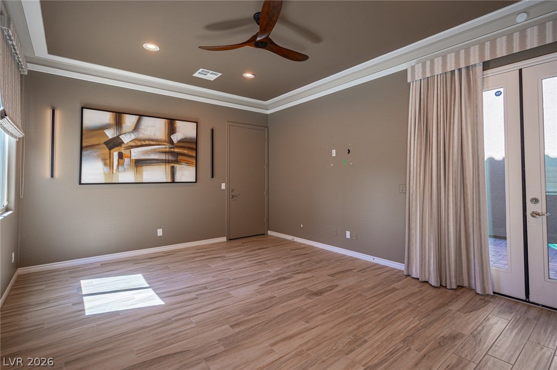 322 Elder View Drive, Las Vegas, NV 89138 Wood-look tile flooring and a tray ceiling define this versatile living space.
