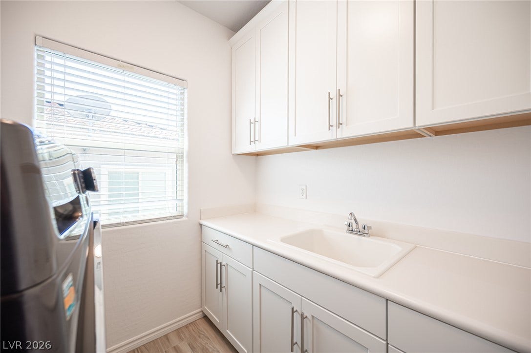 322 Elder View Drive, Las Vegas, NV 89138 Ample white cabinetry and a built-in sink define this efficient, light-filled workspace.