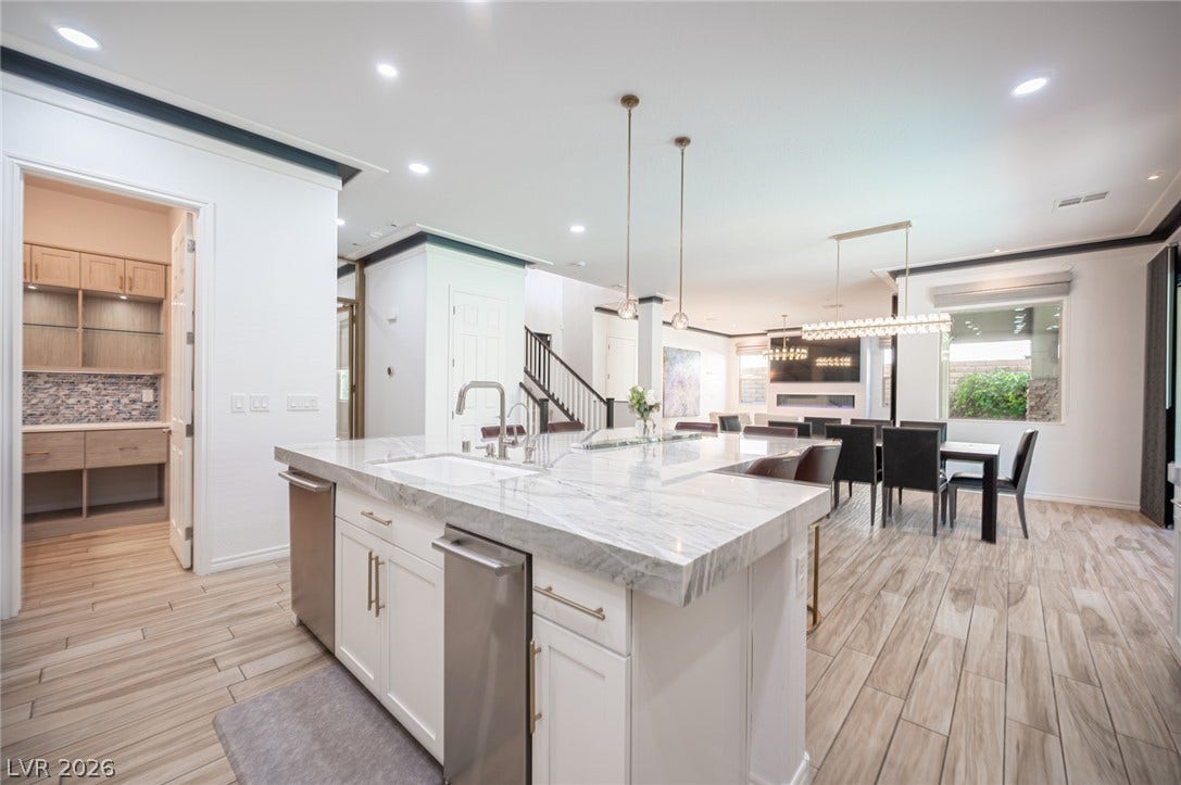 322 Elder View Drive, Las Vegas, NV 89138 An open floorplan seamlessly connects the stone-countertop kitchen island to the dining area.