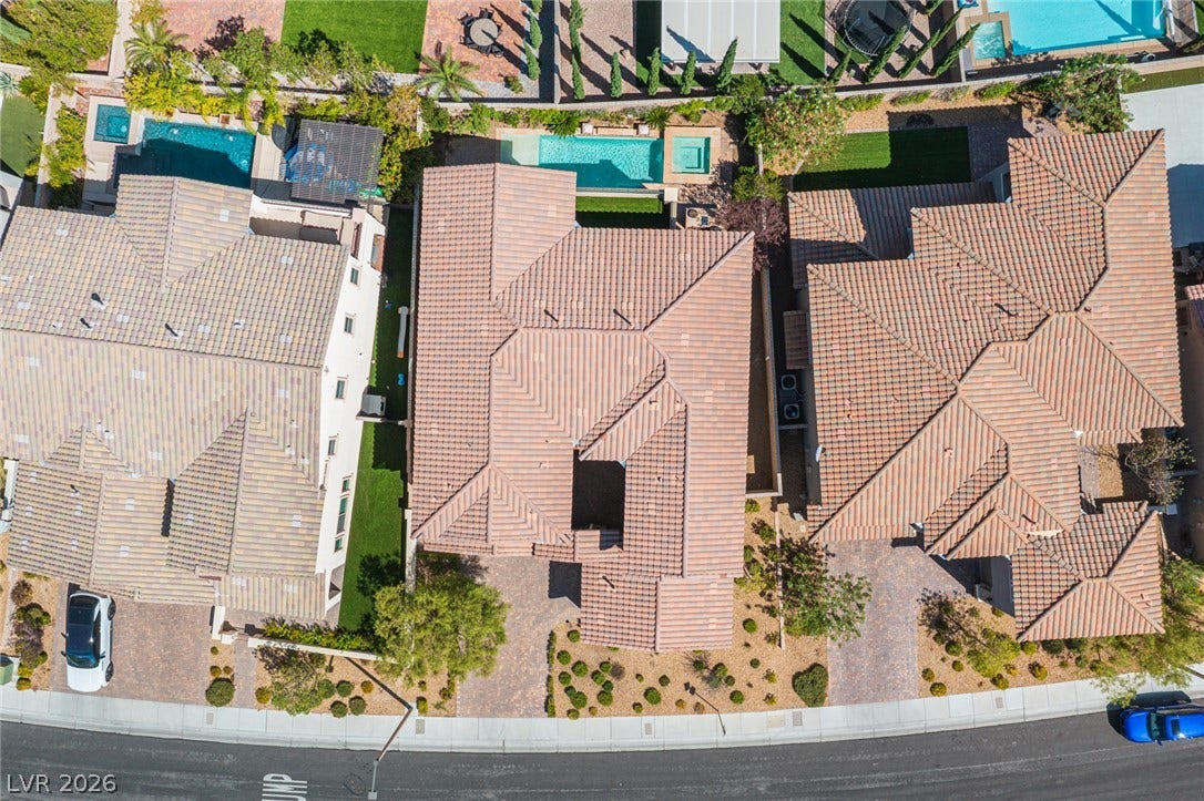 322 Elder View Drive, Las Vegas, NV 89138 An aerial perspective showcases tile rooflines and structured backyard designs in a suburban neighborhood.