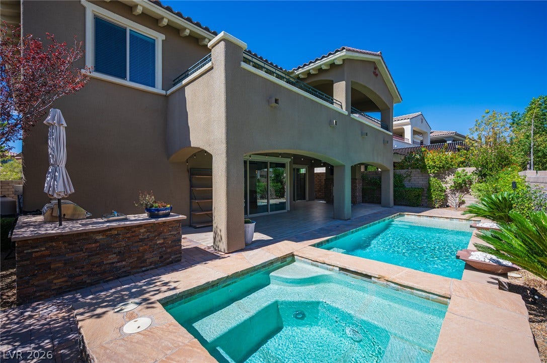 322 Elder View Drive, Las Vegas, NV 89138 An inviting backyard oasis features a built-in spa alongside a sparkling swimming pool.