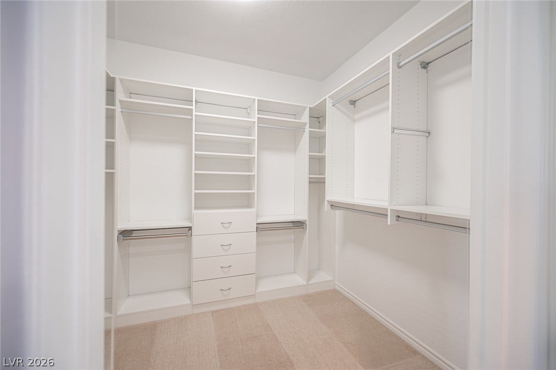 322 Elder View Drive, Las Vegas, NV 89138 Custom built-in shelving and ample hanging rods maximize organization in this closet.