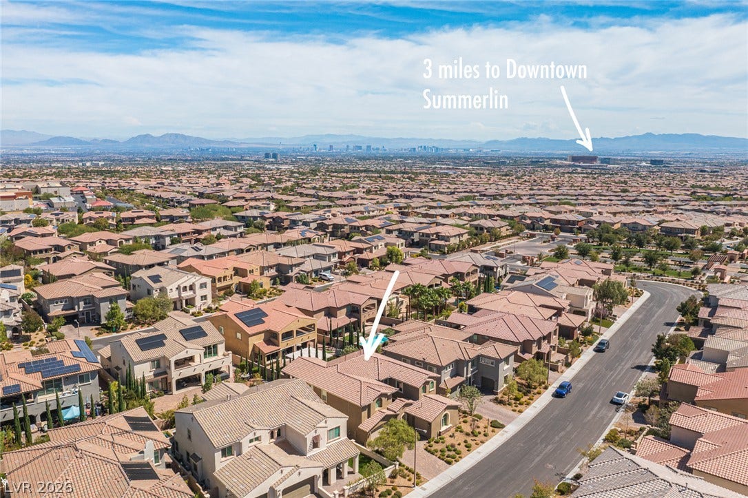 322 Elder View Drive, Las Vegas, NV 89138 A sweeping aerial view showcases the surrounding neighborhood under a blue sky.