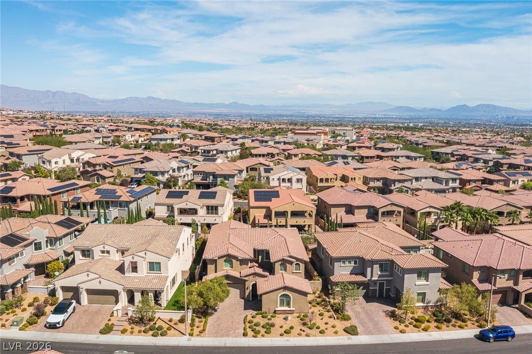 322 Elder View Drive, Las Vegas, NV 89138 Distant mountains frame a sweeping aerial perspective of this peaceful desert hillside neighborhood.