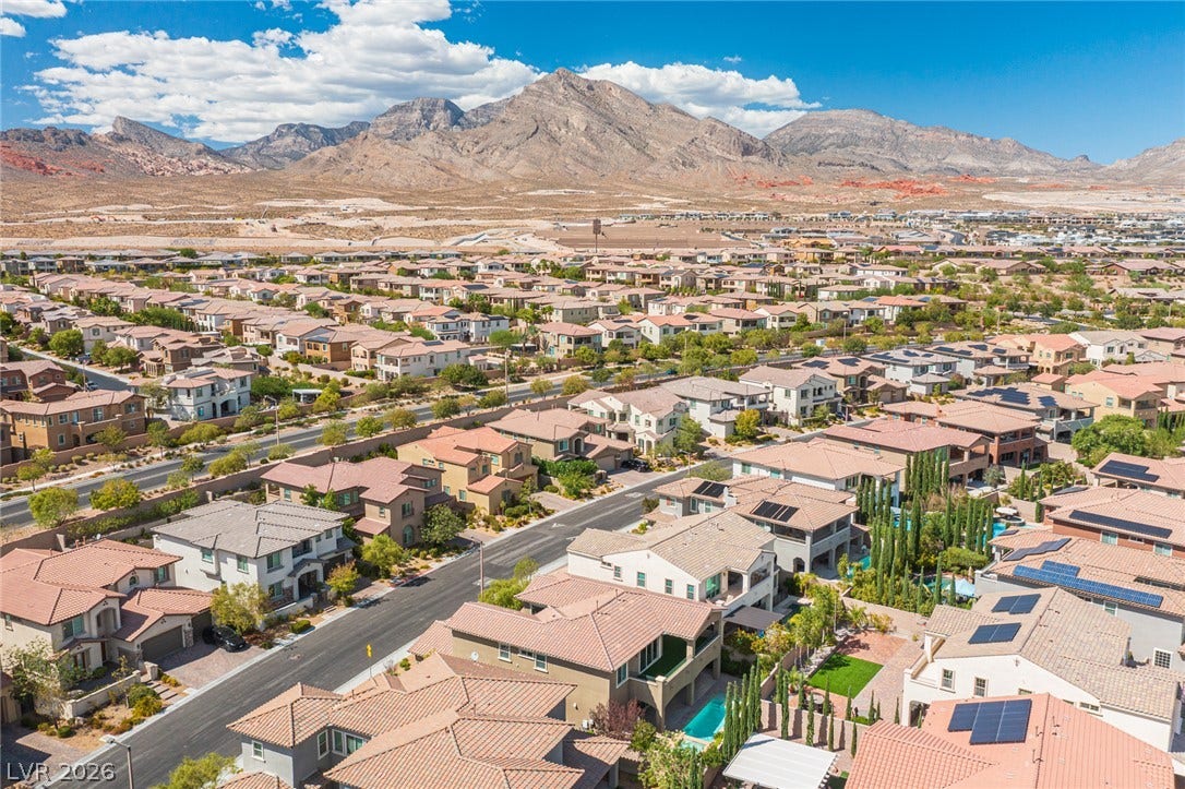 322 Elder View Drive, Las Vegas, NV 89138 Dramatic mountain peaks rise sharply behind a peaceful, sun-drenched suburban neighborhood.