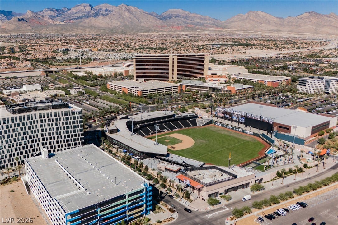 322 Elder View Drive, Las Vegas, NV 89138 Dramatic mountain ranges frame a sprawling landscape of suburban developments and major local landmarks.