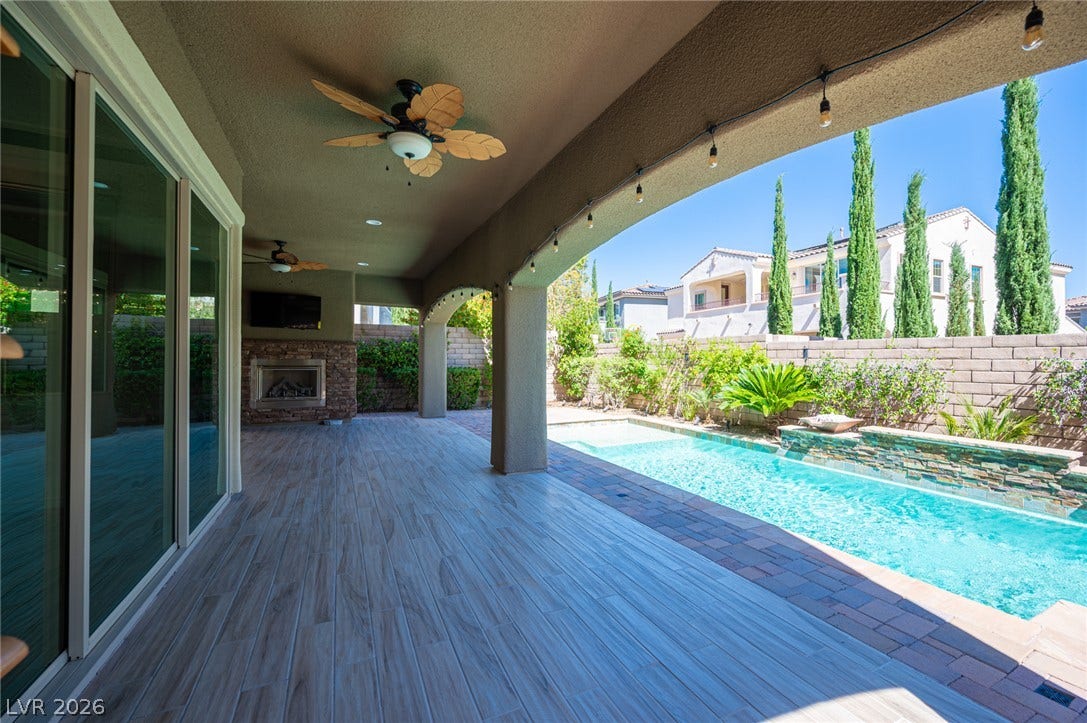 322 Elder View Drive, Las Vegas, NV 89138 An covered patio with tile flooring overlooks a sparkling swimming pool.