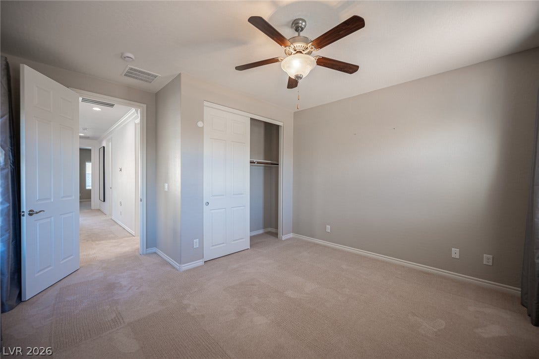 322 Elder View Drive, Las Vegas, NV 89138 Plush carpeting and a built-in closet define this versatile secondary bedroom space.