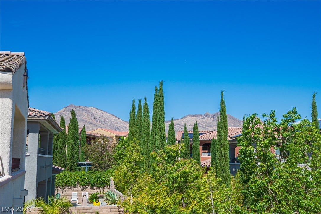 322 Elder View Drive, Las Vegas, NV 89138 Towering trees frame rugged mountain peaks under a clear blue sky.