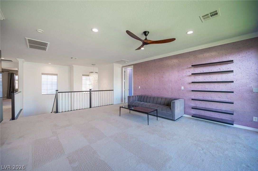 322 Elder View Drive, Las Vegas, NV 89138 Plush carpeting anchors a versatile upstairs loft featuring built-in floating wall shelves and recessed lighting.