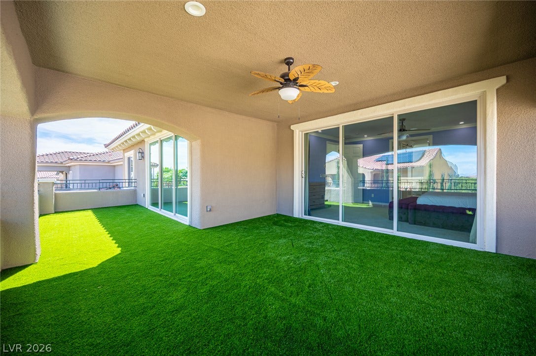 322 Elder View Drive, Las Vegas, NV 89138 Sliding glass doors open onto a spacious, covered balcony featuring artificial turf flooring.