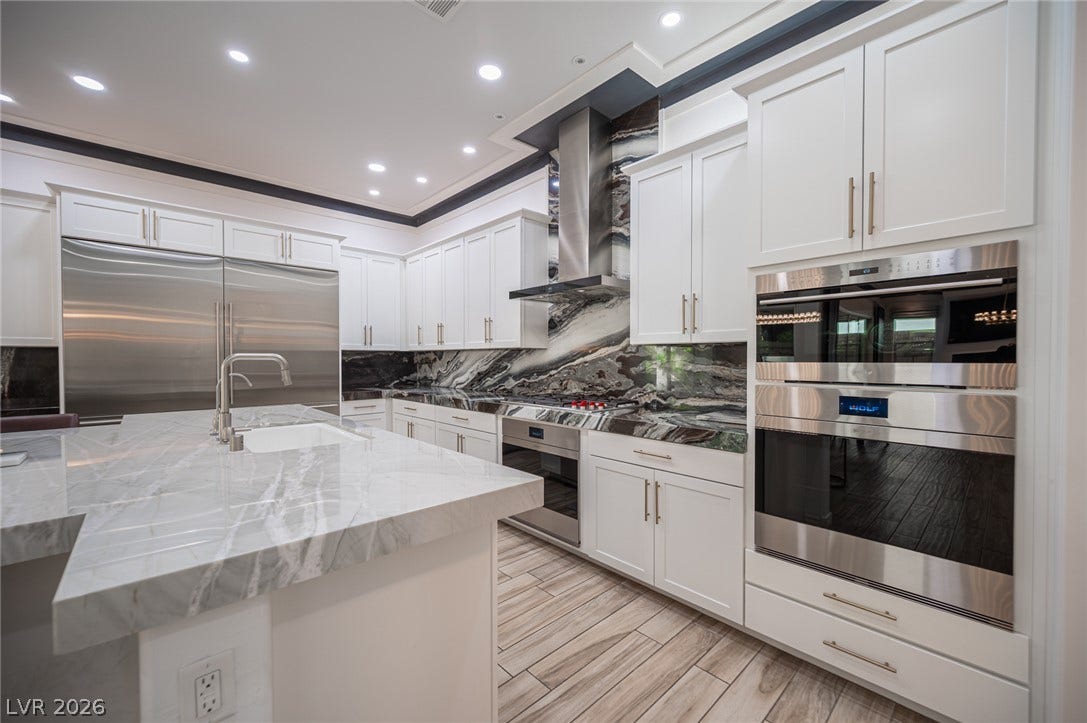 322 Elder View Drive, Las Vegas, NV 89138 Gleaming stone countertops and modern built-in appliances highlight this gourmet cooking space.